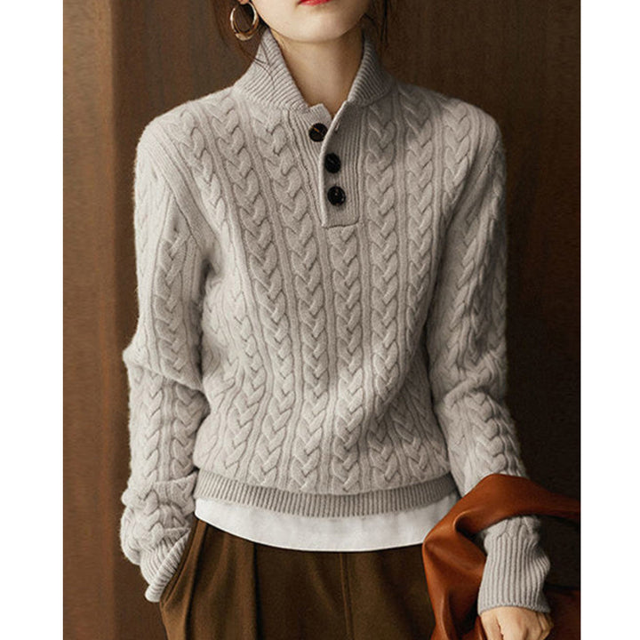 Simple and comfortable women's sweater made of thick knit, in a solid color, with a stand-up collar and buttons