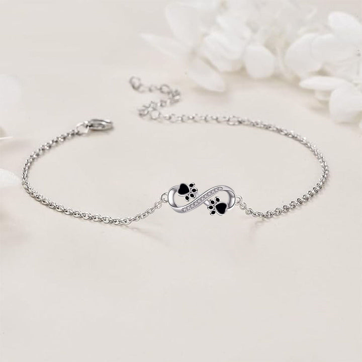 Bracelet with Infinity Symbol, Paw Print Charms, and Zirconia