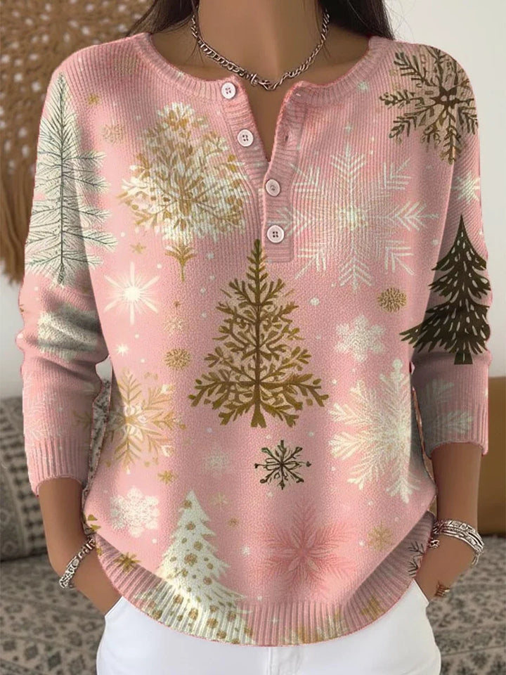 Elegant and cozy pink sweater with a snowflake and pine tree pattern and decorative buttons at the neckline