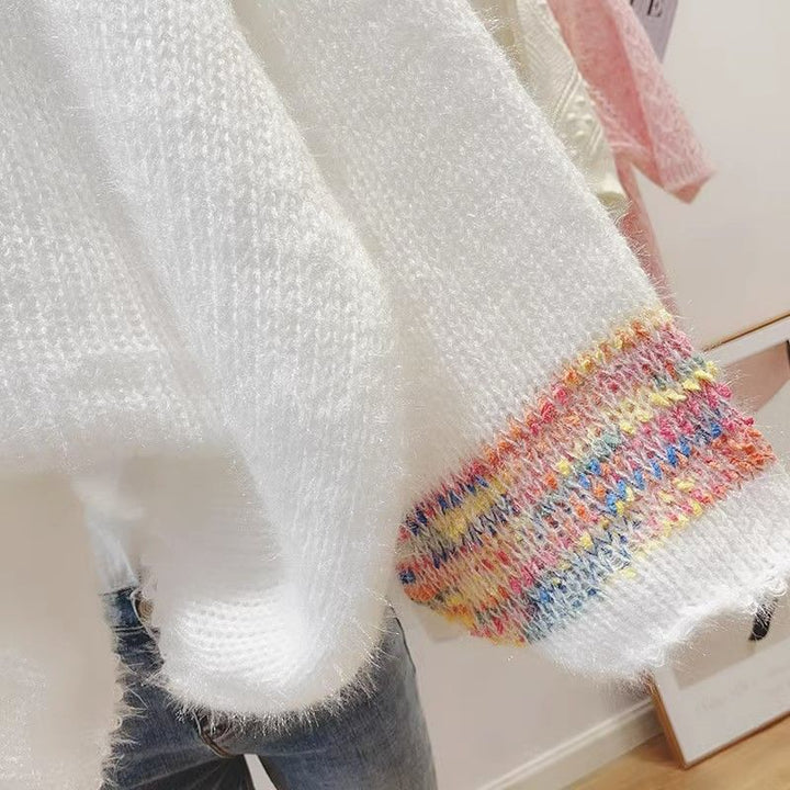 Elegant, loose white sweater with puff sleeves and colorful horizontal stripes