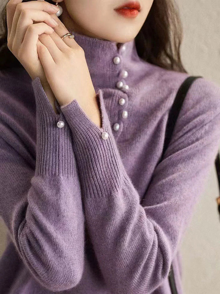 Simple and comfortable women's sweater with a turtleneck, adorned with pearl buttons at the collar