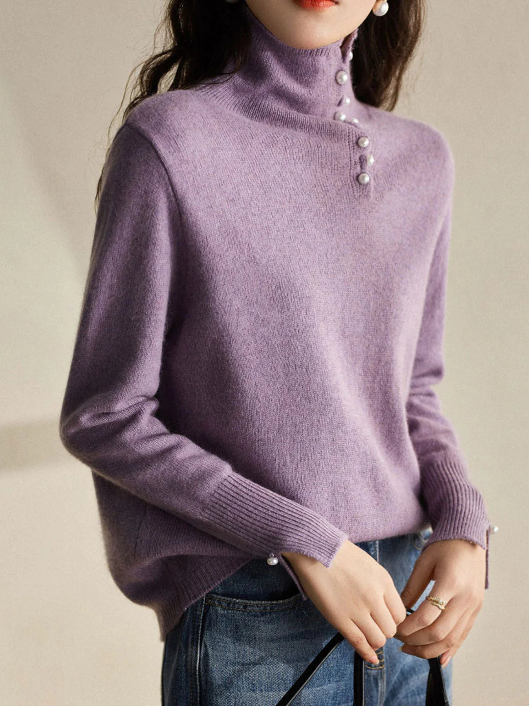 Simple and comfortable women's sweater with a turtleneck, adorned with pearl buttons at the collar