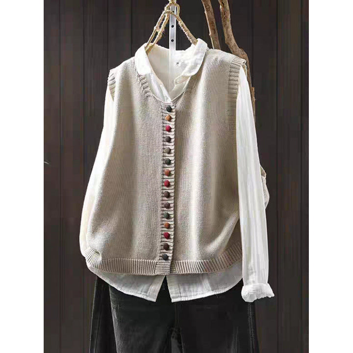 Loose, universal sleeveless sweater-vest in a solid color with colorful buttons