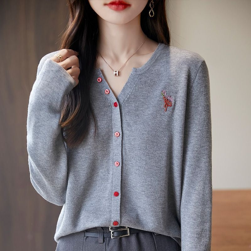 Elegant and comfortable women's cardigan in a solid color with a V-neck and red buttons
