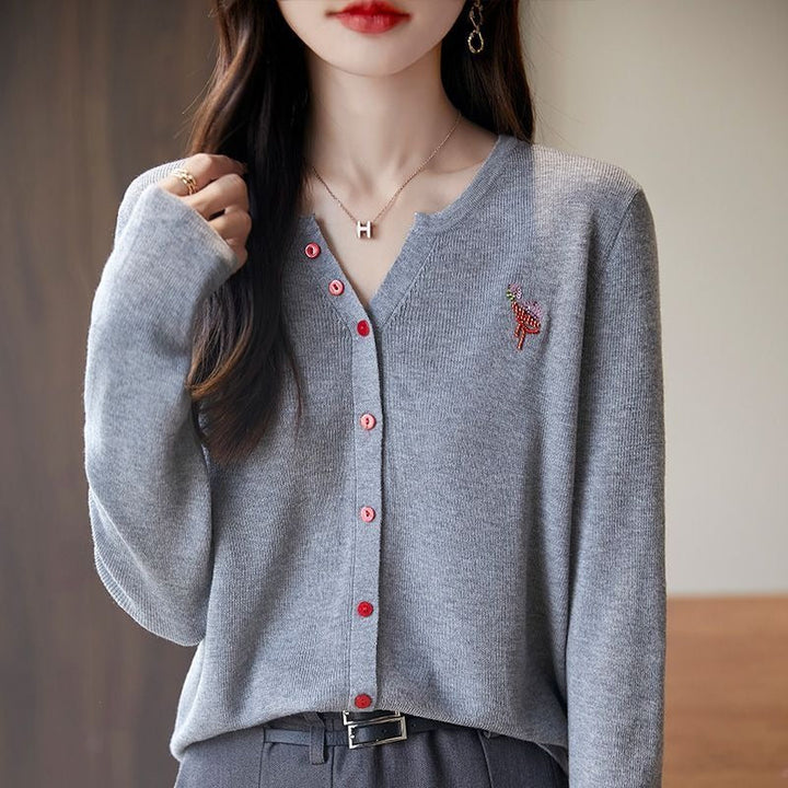 Elegant and comfortable women's cardigan in a solid color with a V-neck and red buttons