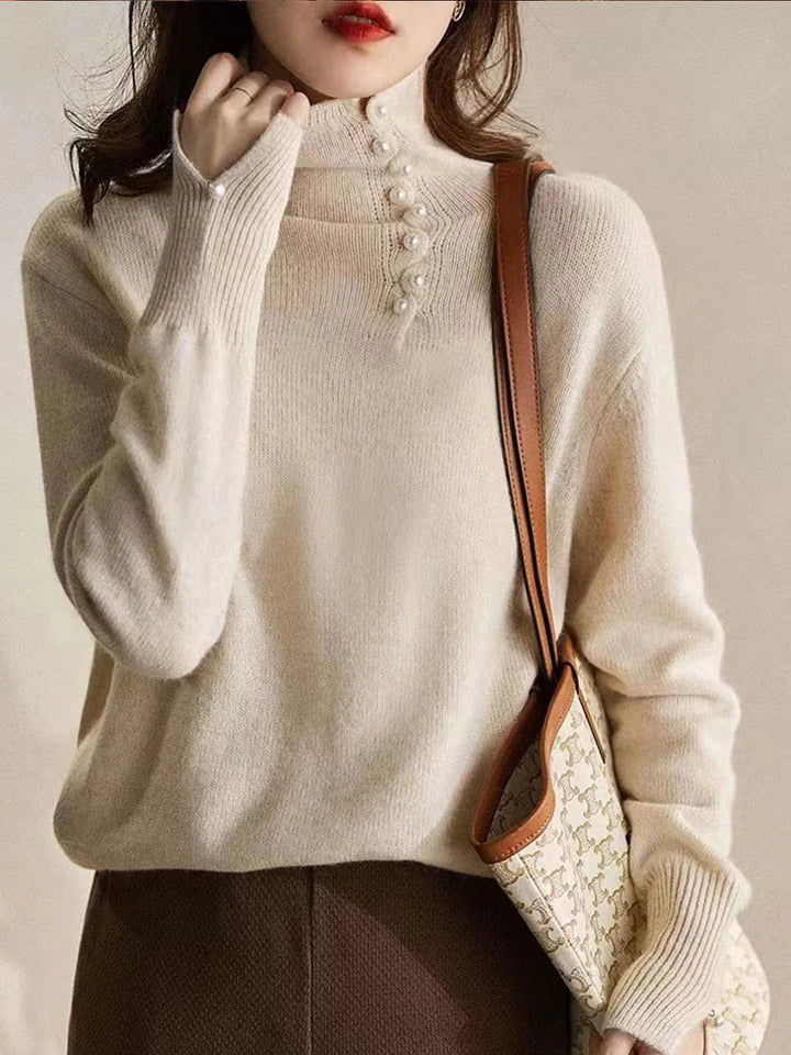 Simple and comfortable women's sweater with a turtleneck, adorned with pearl buttons at the collar