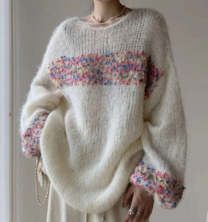 Elegant, loose white sweater with puff sleeves and colorful horizontal stripes