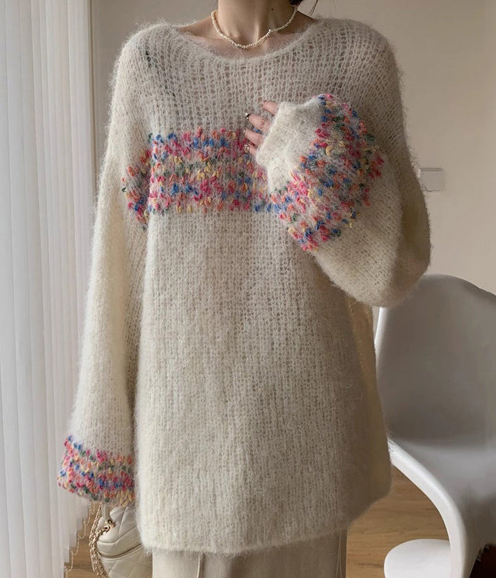 Elegant, loose white sweater with puff sleeves and colorful horizontal stripes