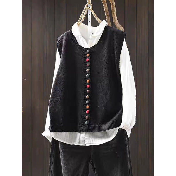 Loose, universal sleeveless sweater-vest in a solid color with colorful buttons