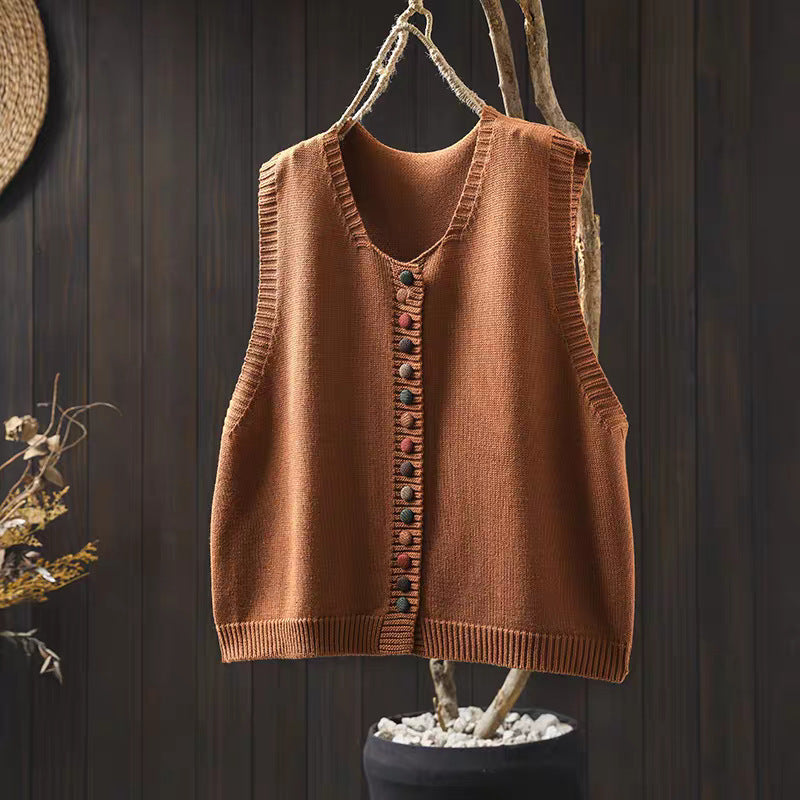 Loose, universal sleeveless sweater-vest in a solid color with colorful buttons