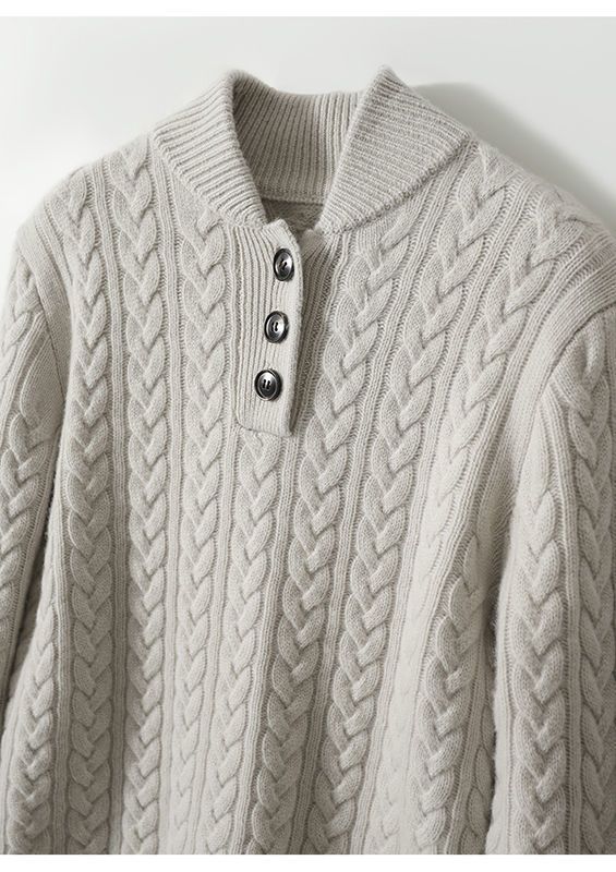 Simple and comfortable women's sweater made of thick knit, in a solid color, with a stand-up collar and buttons