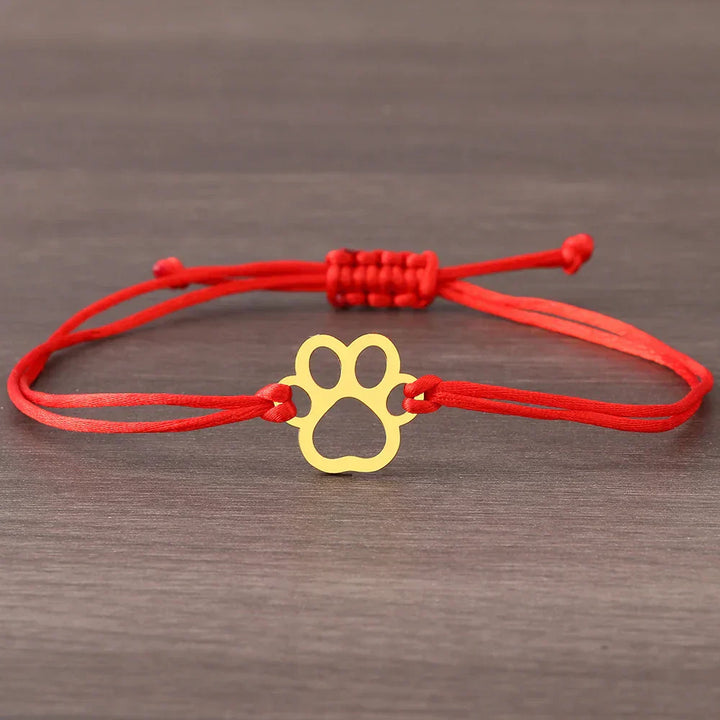 Adjustable bracelet with paw and black and red cord