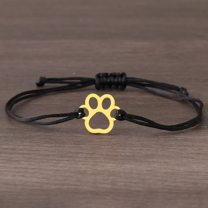 Adjustable bracelet with paw and black and red cord