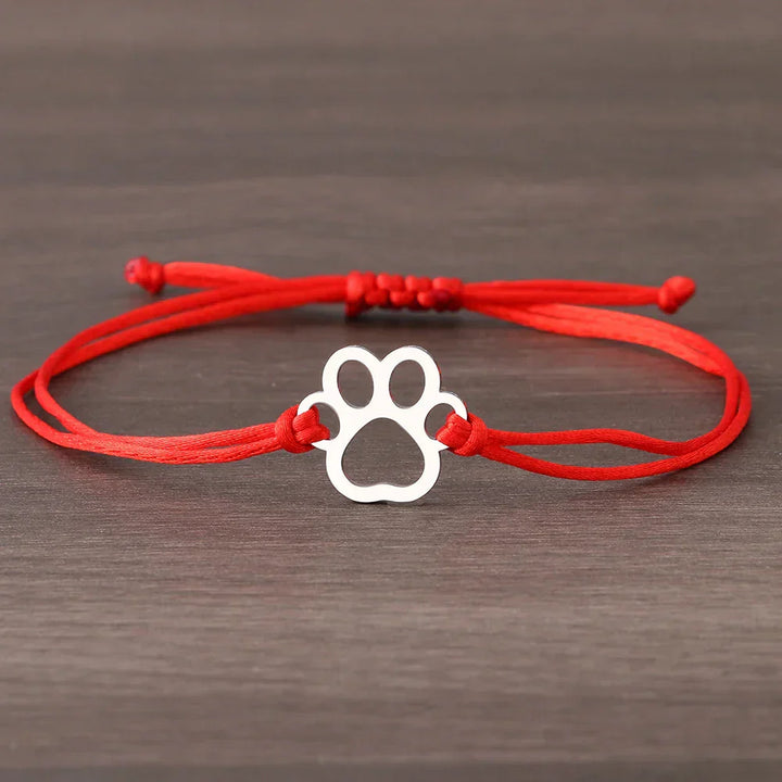 Adjustable bracelet with paw and black and red cord