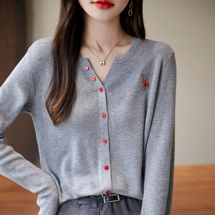Elegant and comfortable women's cardigan in a solid color with a V-neck and red buttons