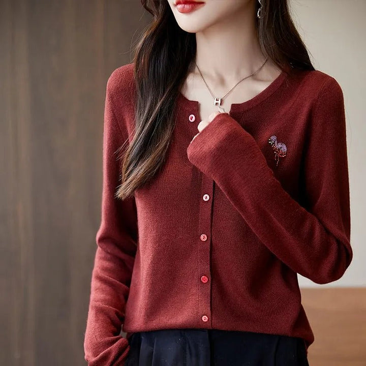 Elegant and comfortable women's cardigan in a solid color with a V-neck and red buttons