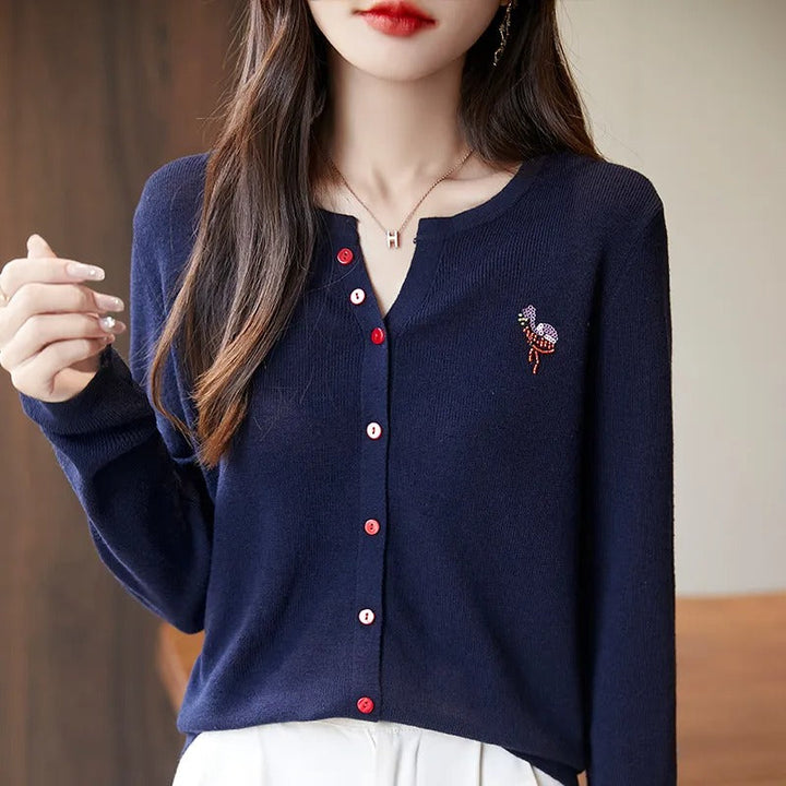 Elegant and comfortable women's cardigan in a solid color with a V-neck and red buttons