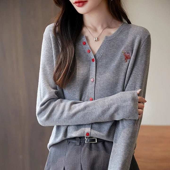 Elegant and comfortable women's cardigan in a solid color with a V-neck and red buttons