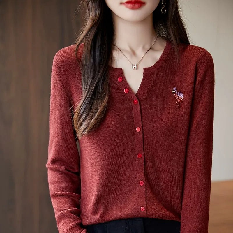 Elegant and comfortable women's cardigan in a solid color with a V-neck and red buttons