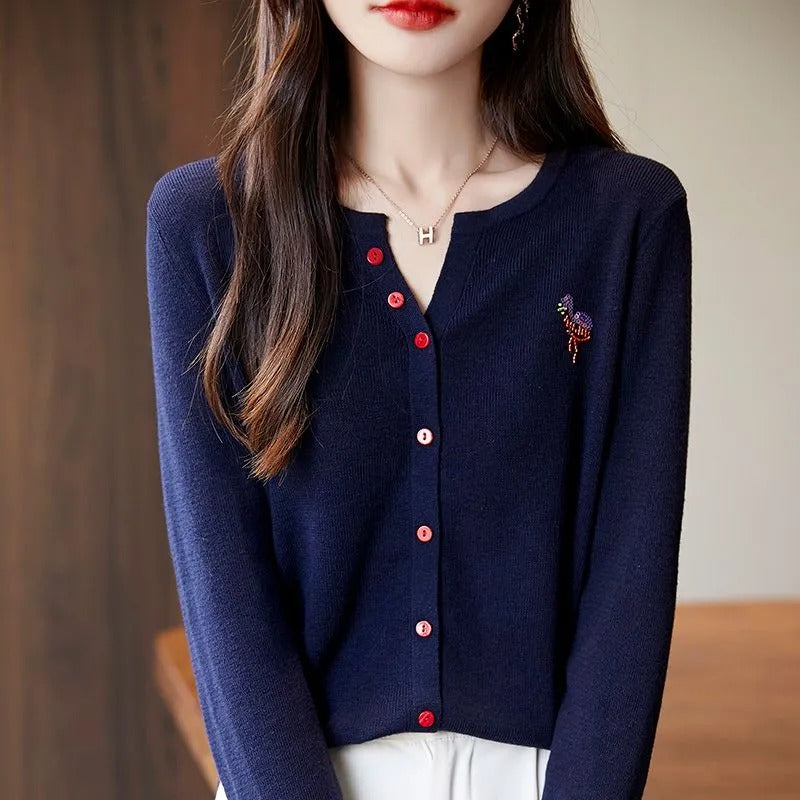 Elegant and comfortable women's cardigan in a solid color with a V-neck and red buttons